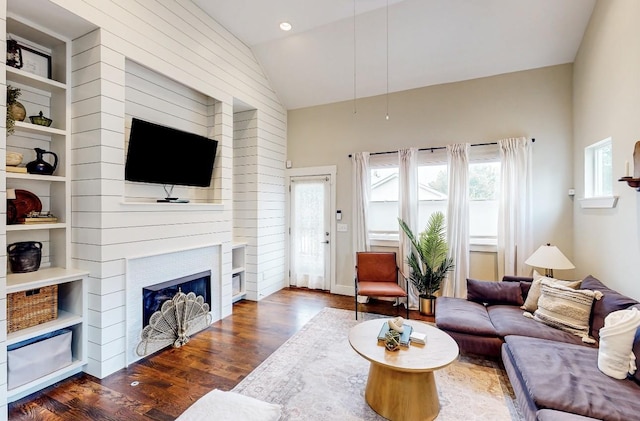 living room featuring vaulted ceiling and dark hardwood / wood-style flooring