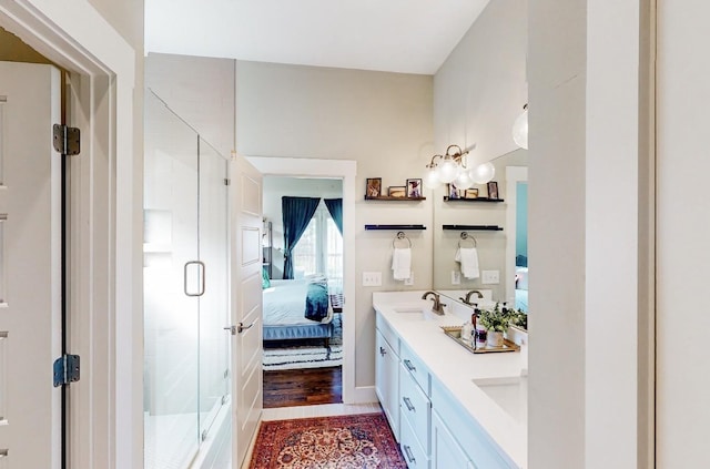 bathroom featuring walk in shower and vanity