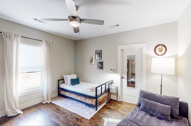 bedroom with ceiling fan and dark hardwood / wood-style flooring