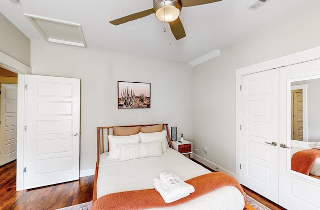 bedroom with dark hardwood / wood-style floors and ceiling fan