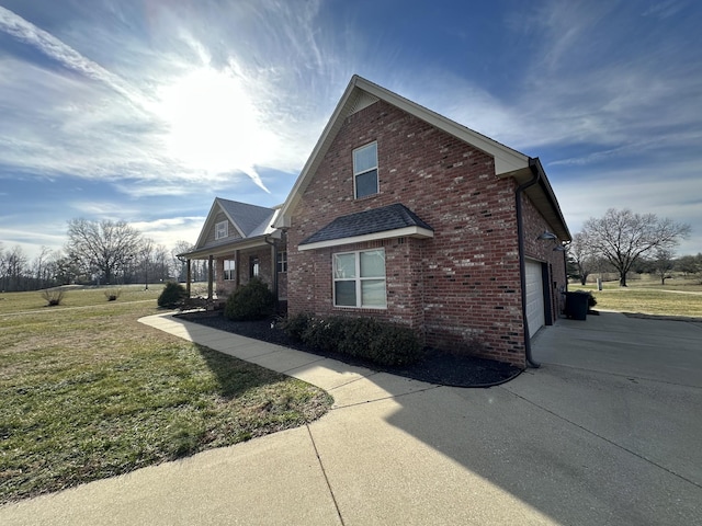 view of home's exterior with a garage and a lawn