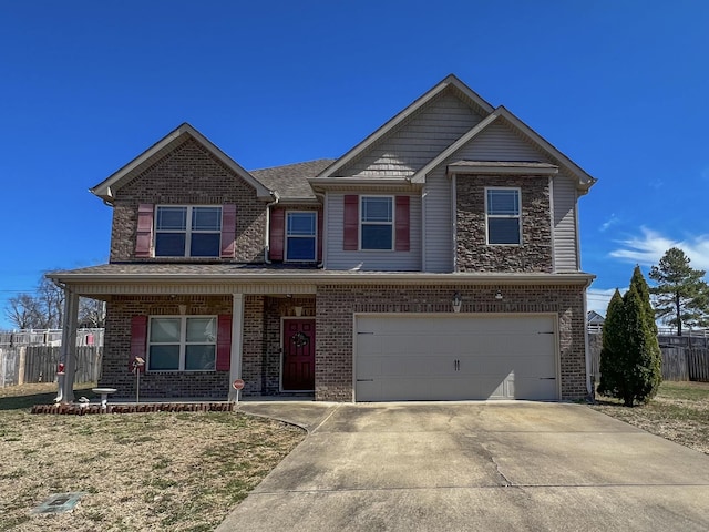 view of front of home with concrete driveway, a garage, fence, and brick siding