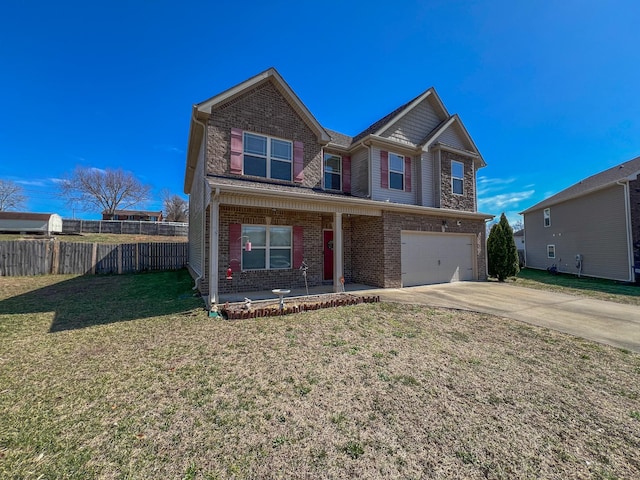 view of front facade featuring a front yard, fence, brick siding, and driveway