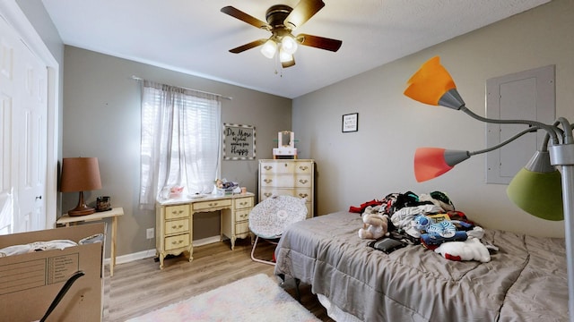 bedroom with ceiling fan, vaulted ceiling, and light wood-type flooring