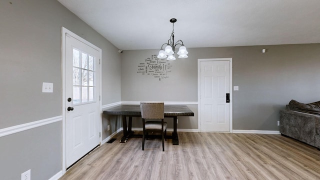 dining room with an inviting chandelier and light hardwood / wood-style floors