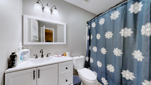 bathroom featuring vanity and toilet