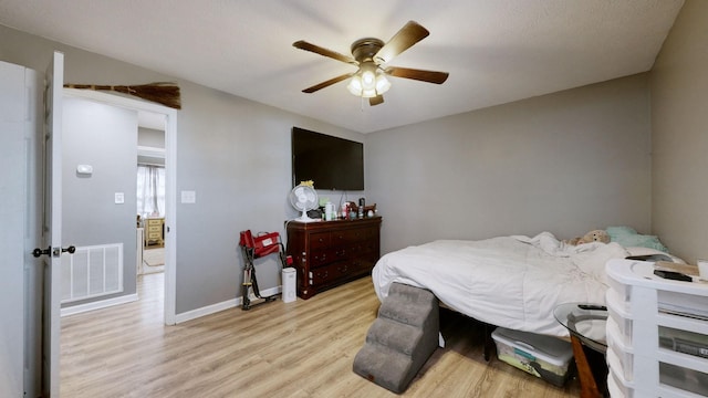 bedroom with ceiling fan and light hardwood / wood-style flooring