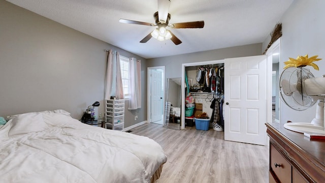 bedroom featuring a closet, ceiling fan, and light hardwood / wood-style flooring