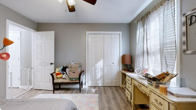 bedroom featuring ceiling fan, light wood-type flooring, and a closet