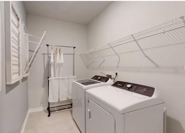 clothes washing area with washing machine and dryer