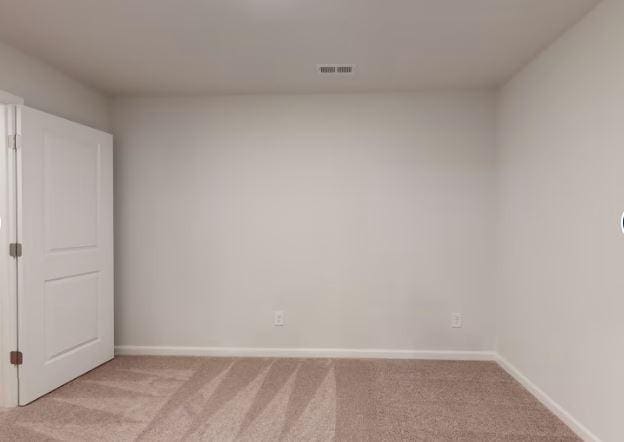 unfurnished room featuring light colored carpet