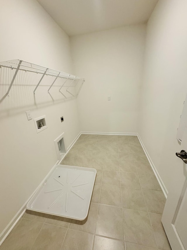 clothes washing area featuring electric dryer hookup, hookup for a washing machine, and tile patterned floors