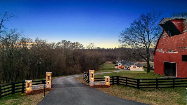 view of street featuring aphalt driveway and a gated entry