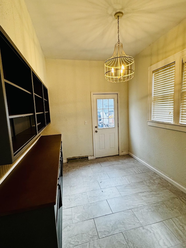 foyer entrance with a chandelier