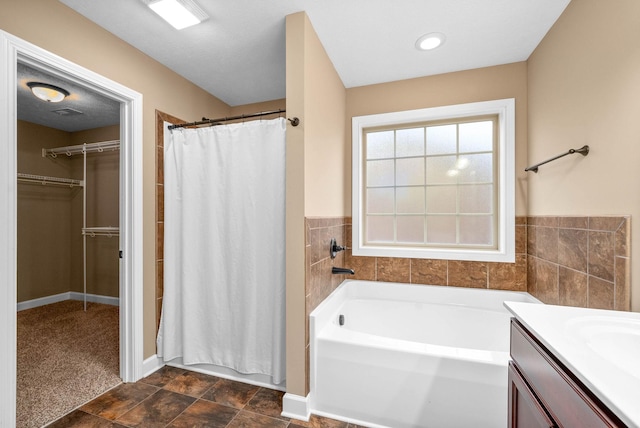 bathroom with vanity and separate shower and tub