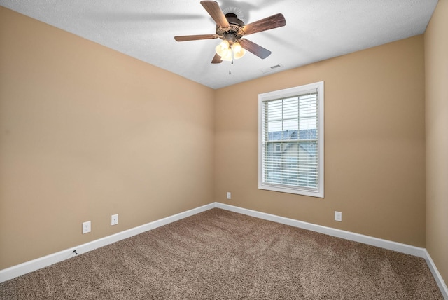 spare room featuring carpet floors and ceiling fan