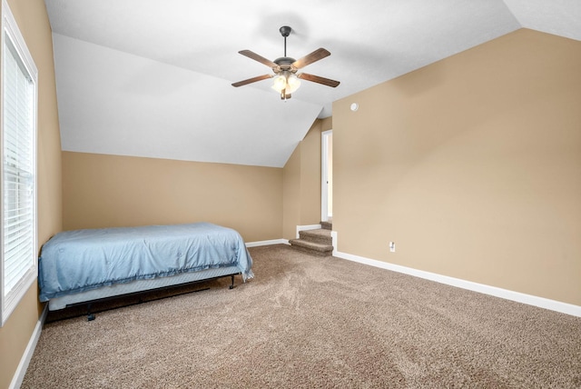 unfurnished bedroom with lofted ceiling, ceiling fan, and carpet