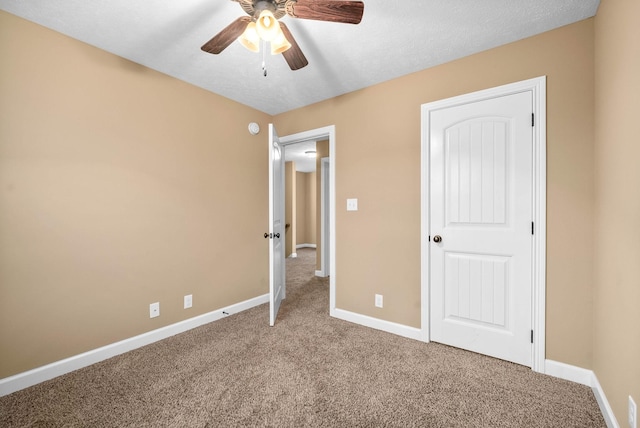 unfurnished bedroom with ceiling fan and carpet