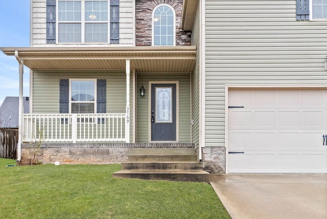 property entrance featuring a garage, a yard, and a porch