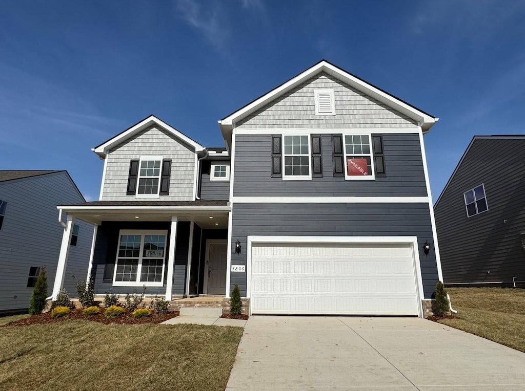 view of front facade with a garage and a front lawn