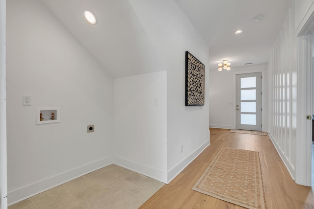 interior space with washer hookup, hardwood / wood-style flooring, and hookup for an electric dryer