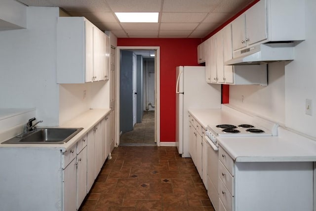 kitchen featuring sink, white appliances, a paneled ceiling, and white cabinets