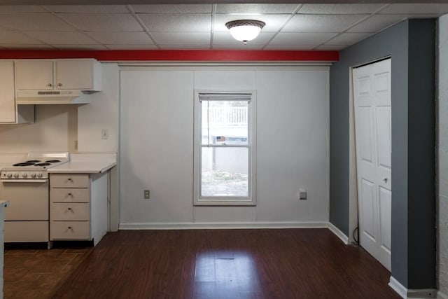 kitchen featuring electric stove, a paneled ceiling, dark hardwood / wood-style flooring, and white cabinetry