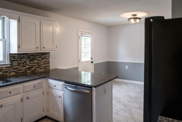 kitchen featuring dishwasher, white cabinets, decorative backsplash, kitchen peninsula, and black fridge