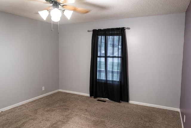 spare room with ceiling fan, a textured ceiling, and carpet flooring