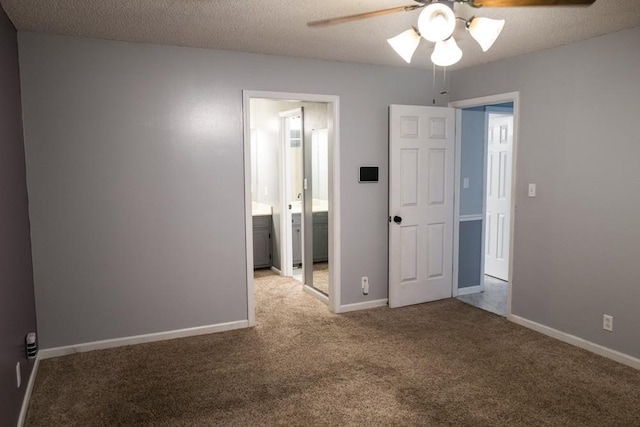 unfurnished room featuring ceiling fan, carpet floors, and a textured ceiling