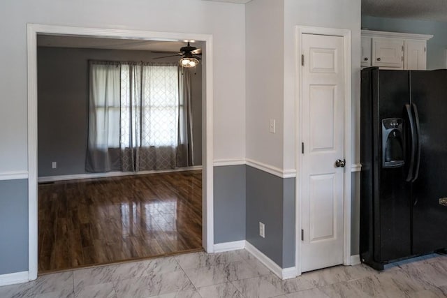 kitchen featuring white cabinetry, ceiling fan, and black refrigerator with ice dispenser