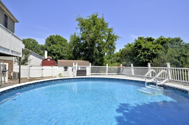 view of pool with central air condition unit