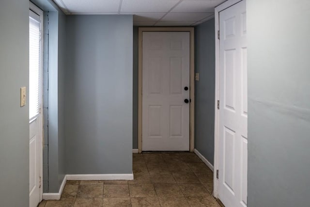 hall with a paneled ceiling