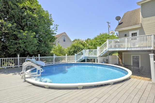 view of swimming pool with a wooden deck