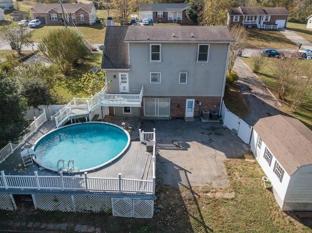 view of swimming pool featuring a wooden deck and central AC