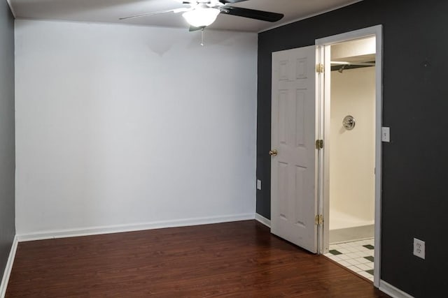 unfurnished bedroom featuring ceiling fan, connected bathroom, and dark hardwood / wood-style flooring