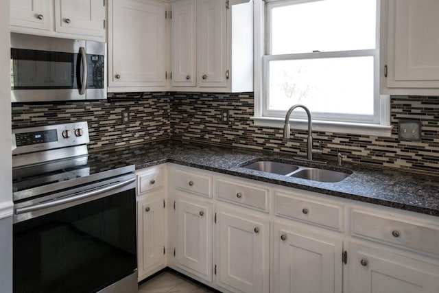 kitchen featuring white cabinetry, sink, decorative backsplash, and appliances with stainless steel finishes