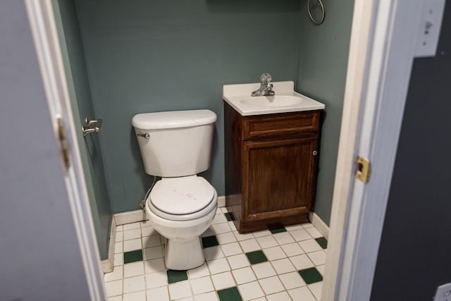 bathroom featuring vanity, toilet, and tile patterned flooring