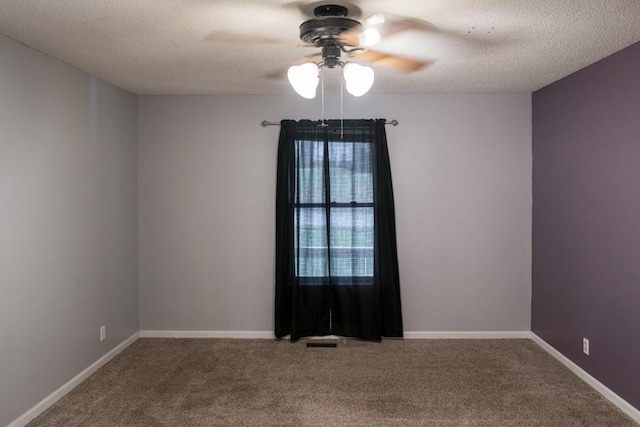 unfurnished room featuring ceiling fan, carpet floors, and a textured ceiling