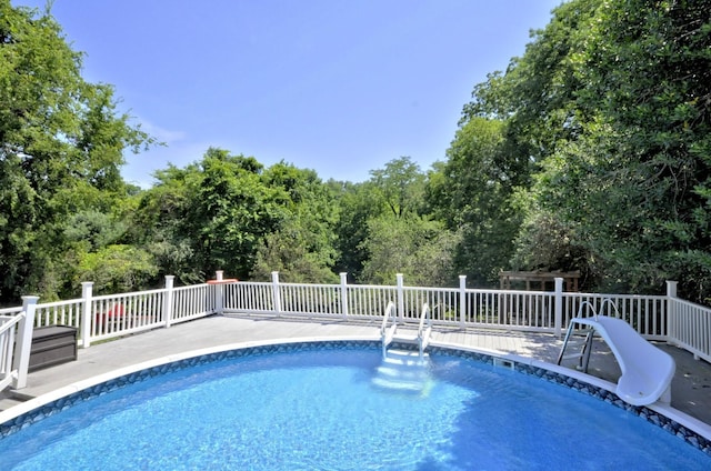 view of pool with a water slide