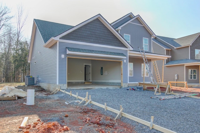 view of front of house featuring a garage and cooling unit