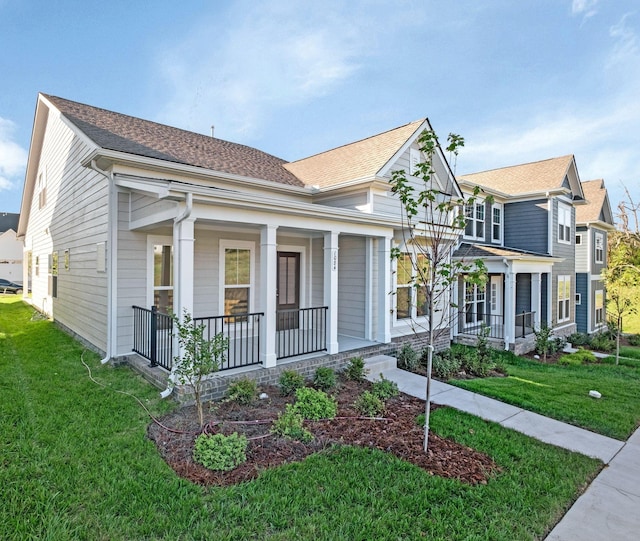 view of front of house with a front yard and a porch