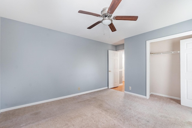 unfurnished bedroom with ceiling fan, light colored carpet, and a closet