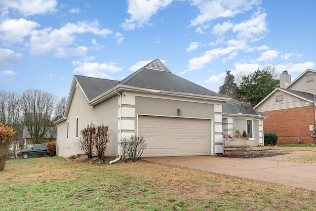 view of front of home with a garage and a front lawn