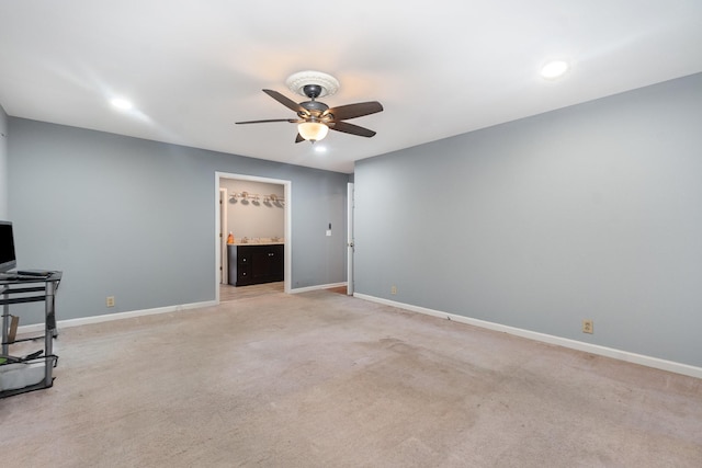 unfurnished living room with light colored carpet and ceiling fan