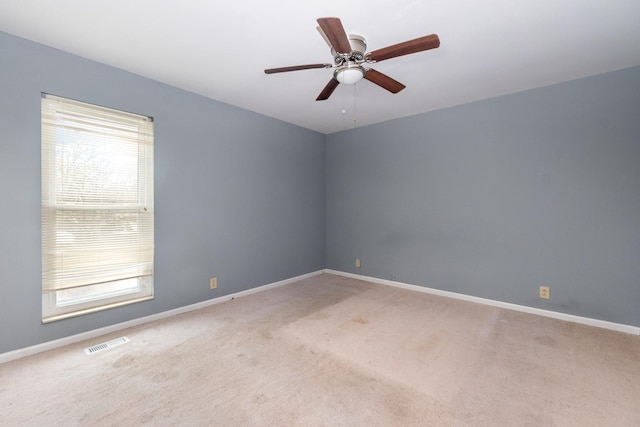 carpeted empty room featuring ceiling fan