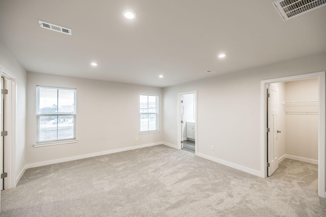 1335 Crescent Ridge Dr, Gallatin, TN 37066 - unfurnished bedroom featuring connected bathroom, a walk in closet, and light colored carpet