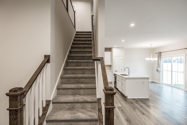 1335 Crescent Ridge Dr, Gallatin, TN 37066 - stairway with an inviting chandelier, sink, and hardwood / wood-style floors