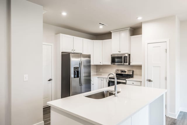 1335 Crescent Ridge Dr, Gallatin, TN 37066 - kitchen featuring sink, dark wood-type flooring, white cabinetry, stainless steel appliances, and an island with sink