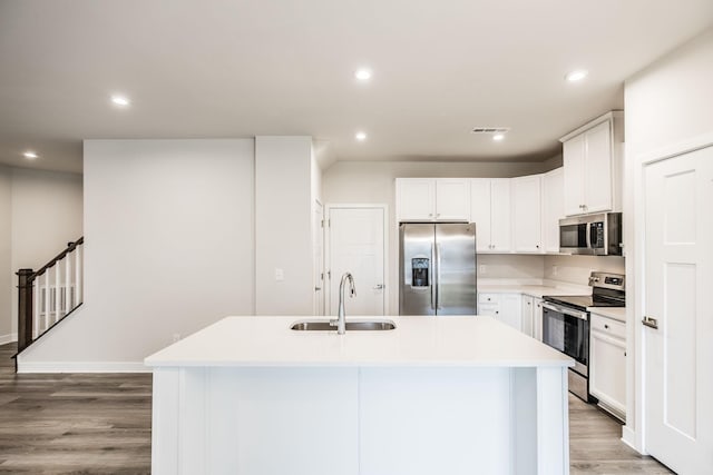 1335 Crescent Ridge Dr, Gallatin, TN 37066 - kitchen featuring sink, light hardwood / wood-style flooring, white cabinetry, stainless steel appliances, and an island with sink